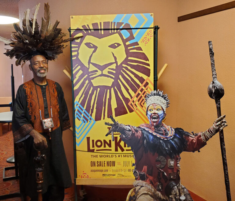 Keith in front of Lion King banner at ASU Gamage
